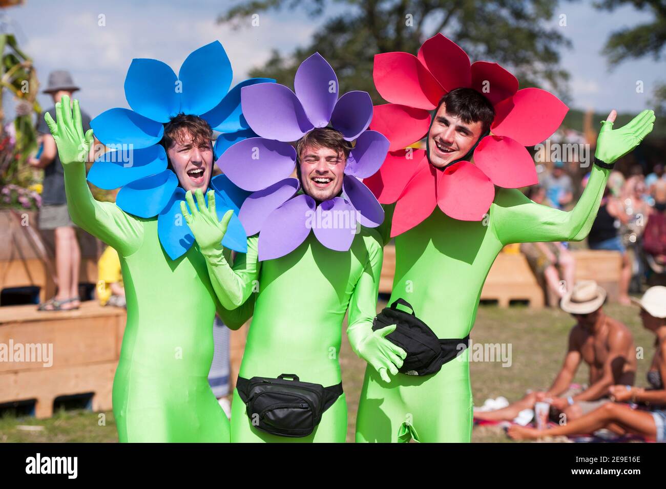 Festival goers in flower costume fancy dress enjoy the fine weather at Shambala Festival, Northamptonshire, UK Stock Photo