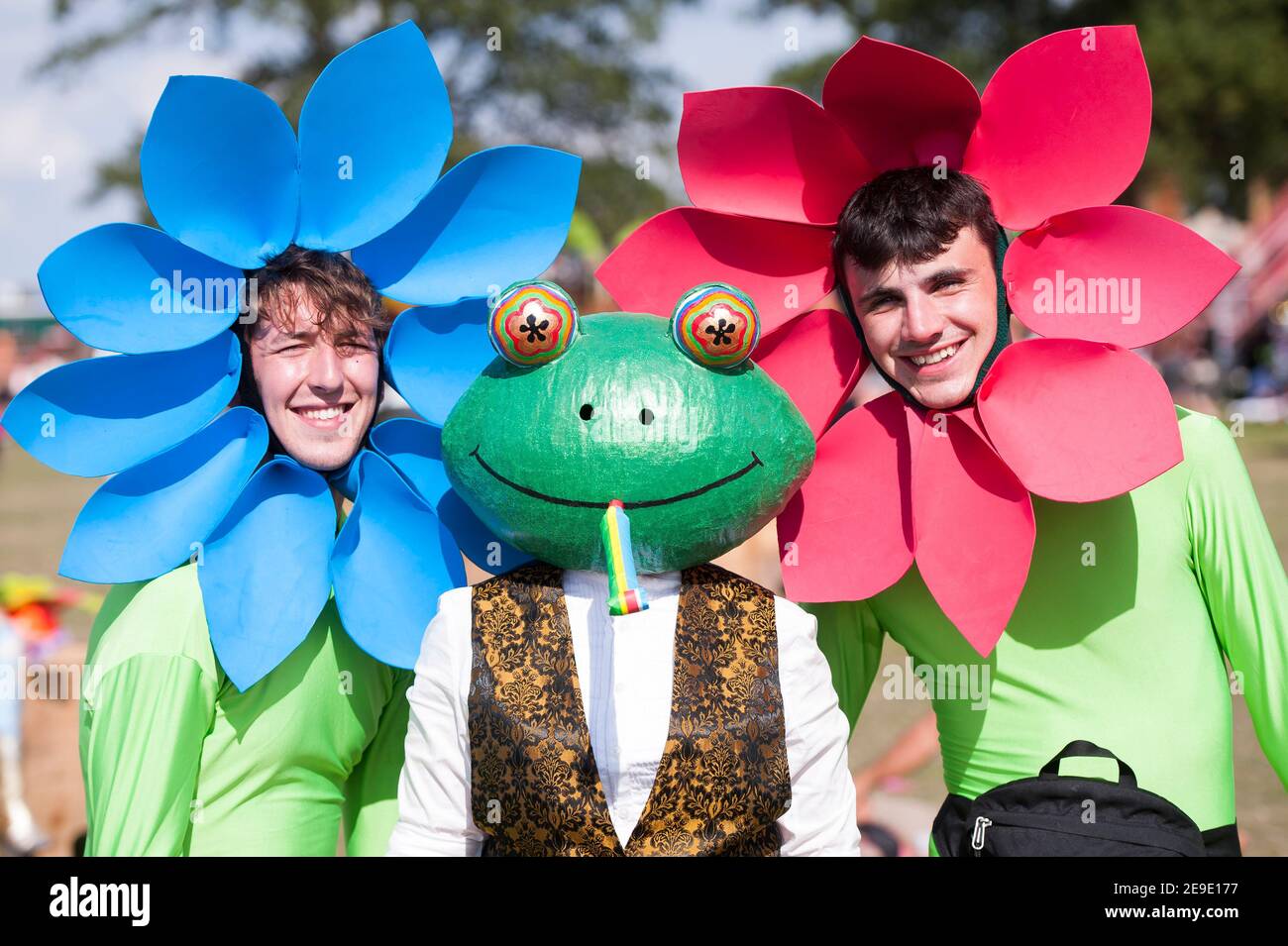 Festival goers in flower costume fancy dress enjoy the fine weather at Shambala Festival, Northamptonshire, UK Stock Photo