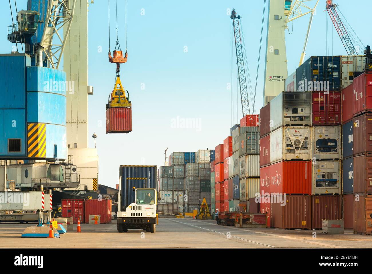 Iquique, Tarapaca Region, Chile - Tower cranes loading trucks witth containers at the Port of Iquique. Stock Photo