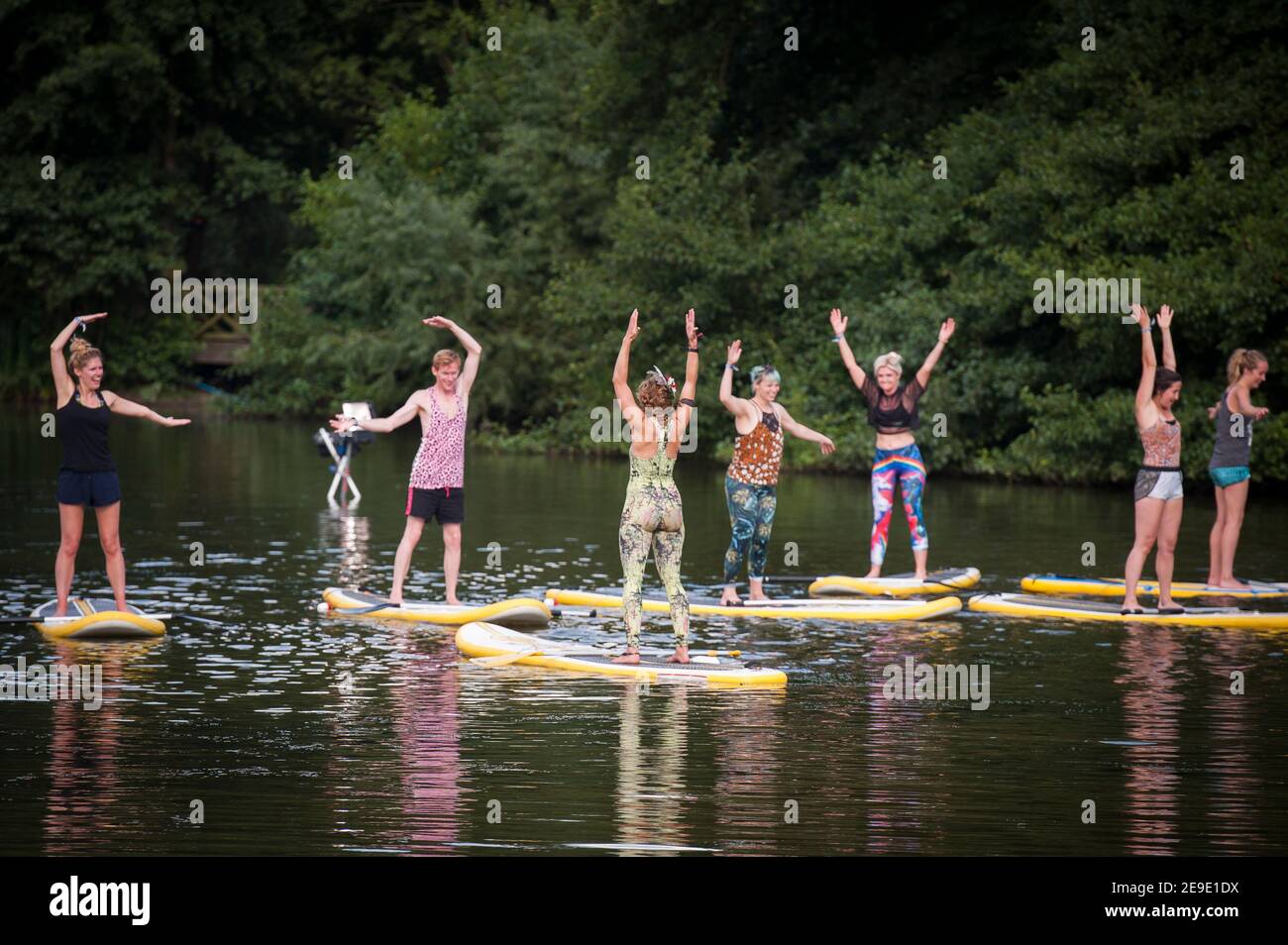 Paddle board Yoga on a lake at Shambala Festival, Kelmarsh, Nothamptonshire, UK Stock Photo