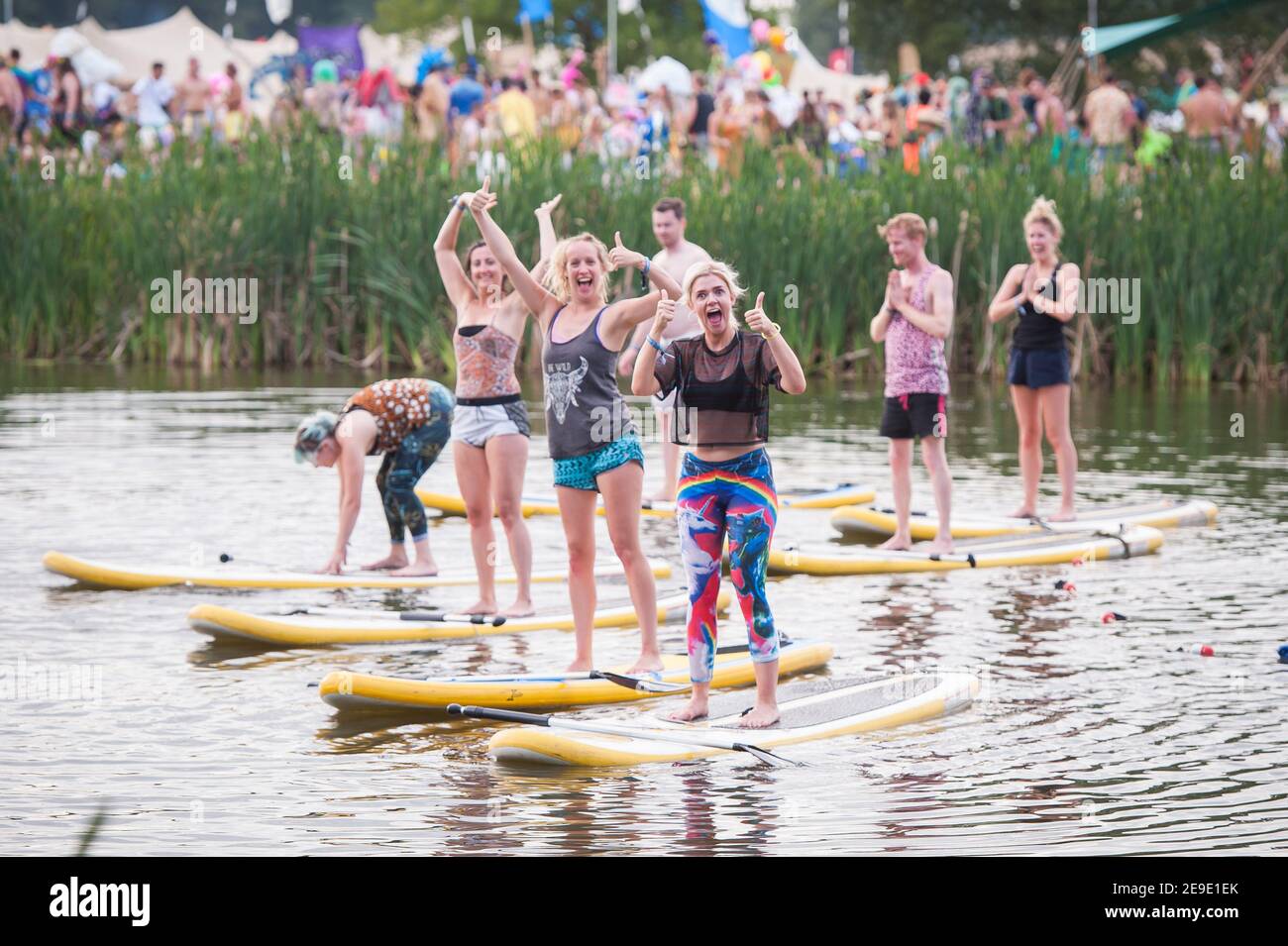 Paddle board Yoga on a lake at Shambala Festival, Kelmarsh, Nothamptonshire, UK Stock Photo