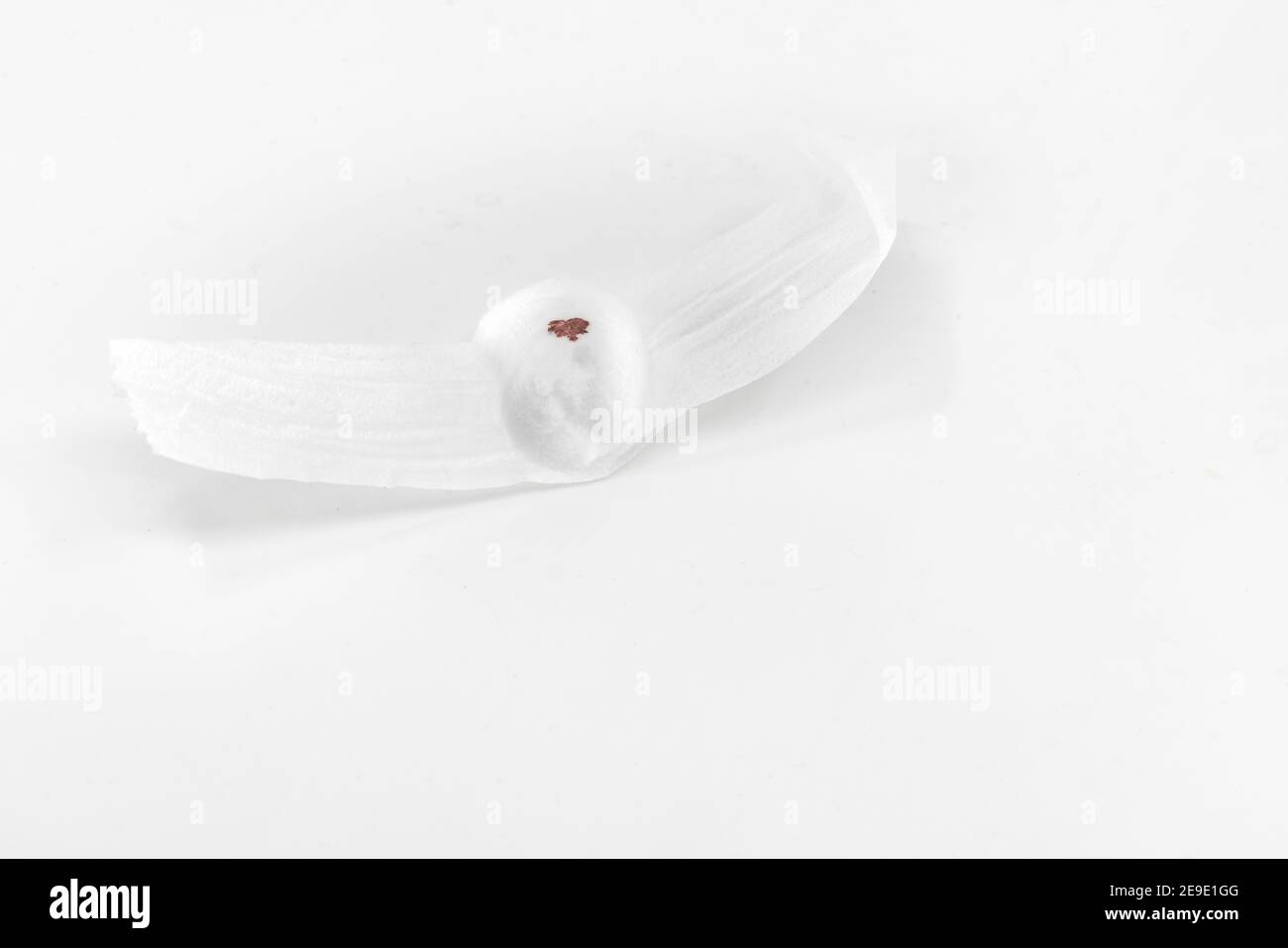 Close up cotton swabs to cover the wound with small blood stains. Blood