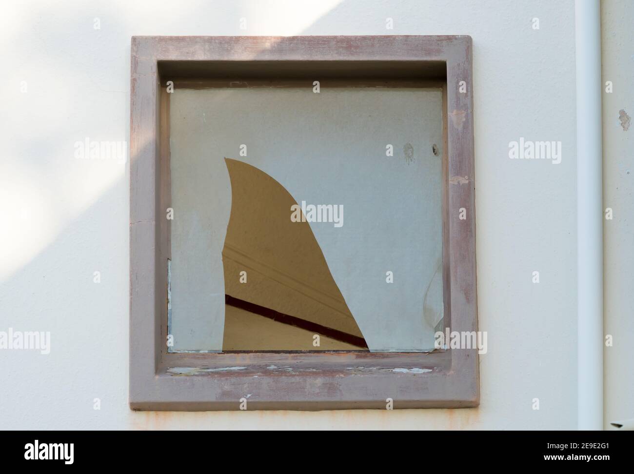 broken window pane glass with a big hole in it concept crime scene Stock Photo