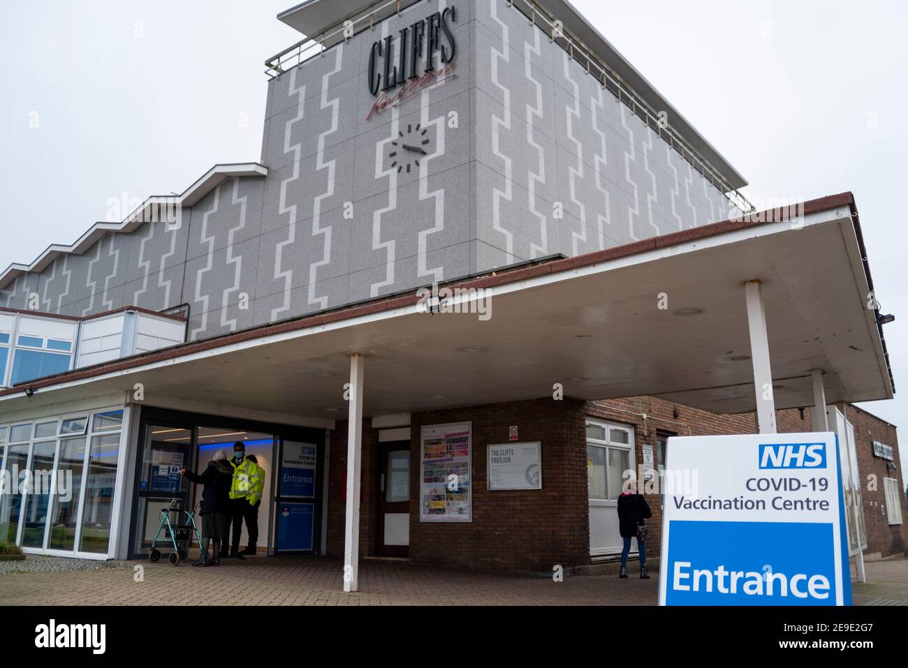 Southend on Sea, Essex, UK. 4th Feb, 2021. The Cliffs Pavilion theatre has today opened as a Coronavirus mass vaccination centre. The theatre has been closed for the duration of the pandemic in the UK with all shows cancelled. The centre has a much larger capacity for vaccinations than other locations opened thus far locally and is among a series opening nationally this week as the NHS rapidly accelerates the number of sites that can give the crucial first dose of the vaccine. Senior person arriving Stock Photo