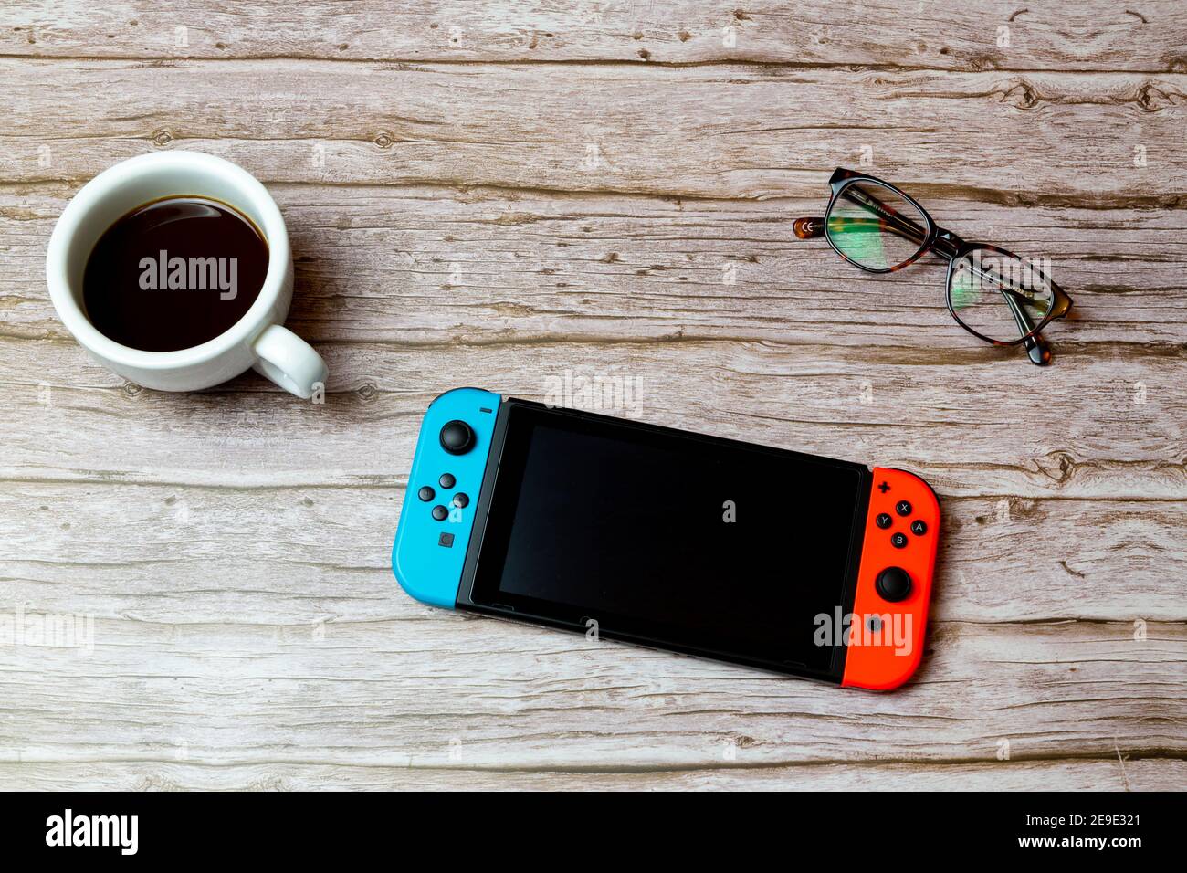 A Nintendo switch games console laid on a desk or table next to a