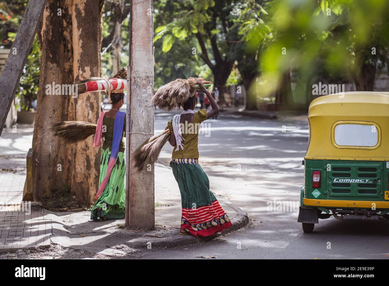 Bengaluru, India - June 08, 2020. Indian women in colorful sarees carrying a bundle on her head. India, Bengaluru Stock Photo