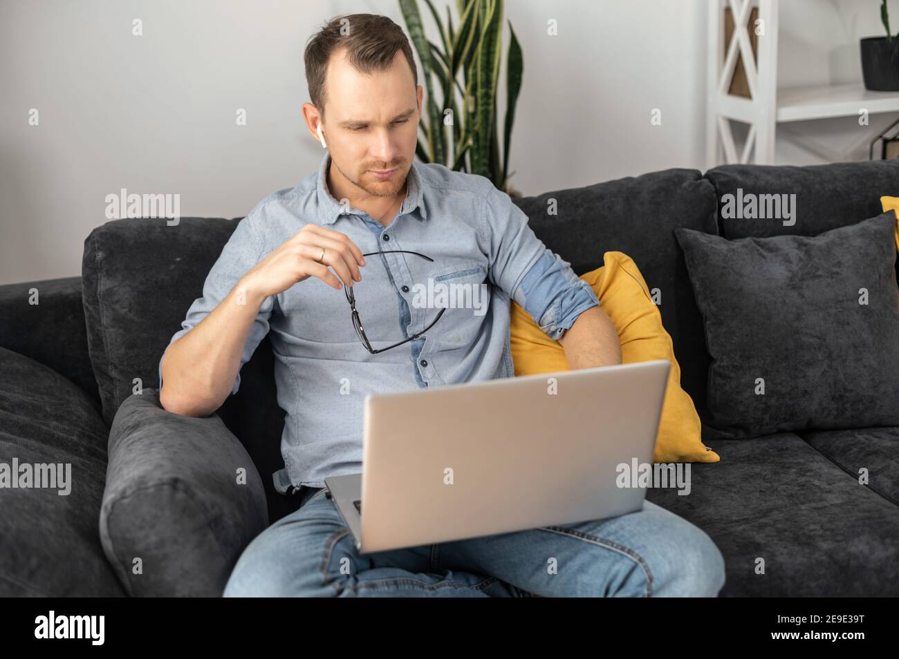 Focused businessman lost in thinks about solving a complex business problem, developing, engineering. A freelancer using laptop for working from home Stock Photo