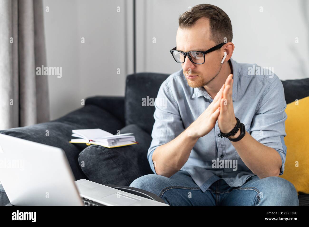 Intelligent businessman lost in thinks about solving a complex business problem, developing, engineering. Freelancer using laptop for working from Stock Photo