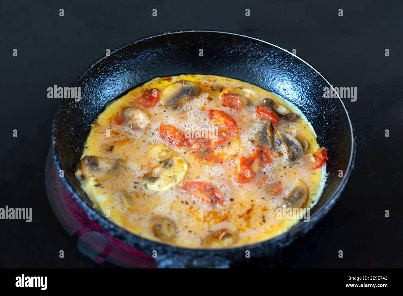 Spanish omelette in a small frying pan Stock Photo