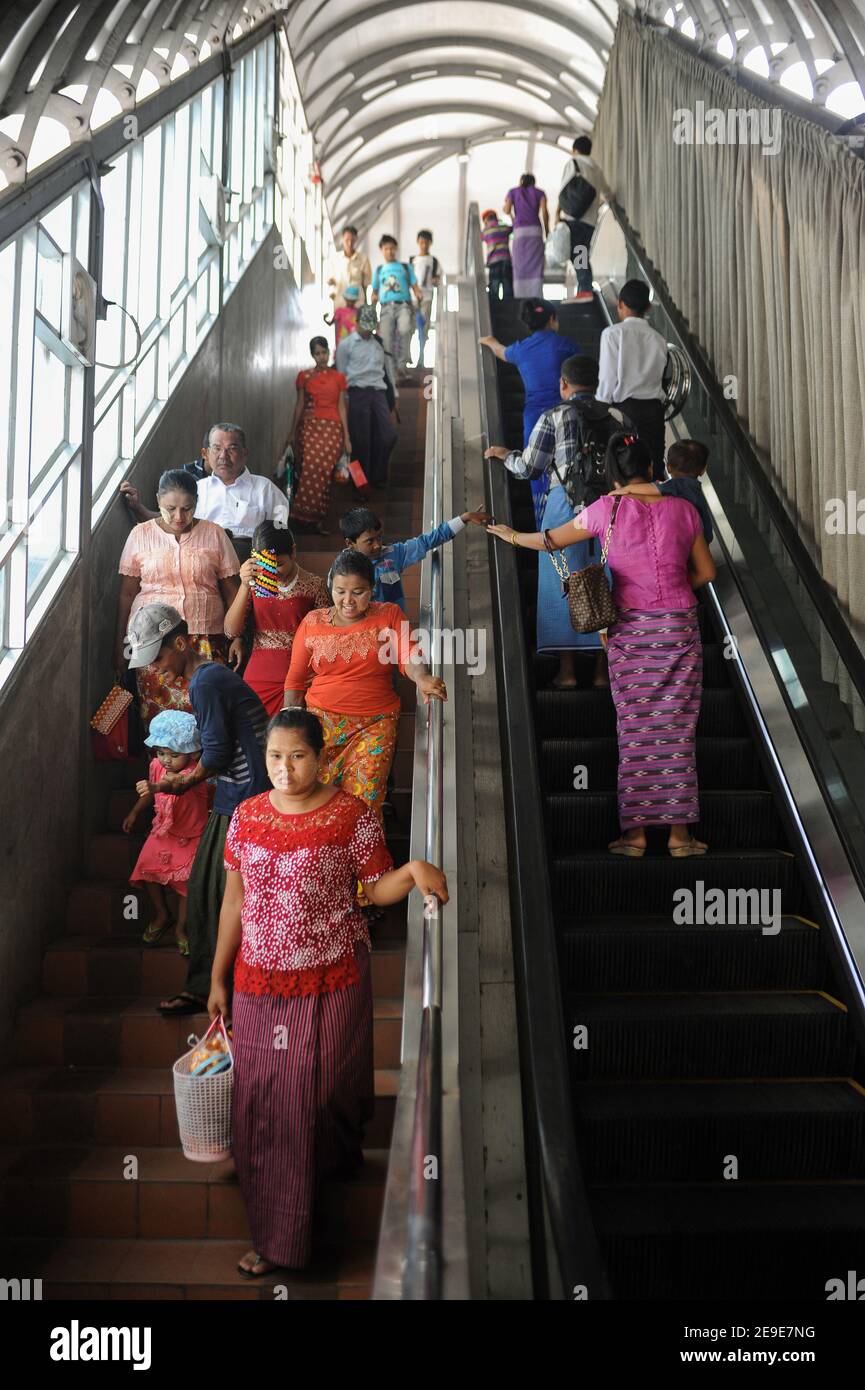 29.10.2015, Yangon, Republic of the Union of Myanmar, Asia - Everyday life scene depicts locals on an escalator that leads to a pedestrian footbridge. Stock Photo