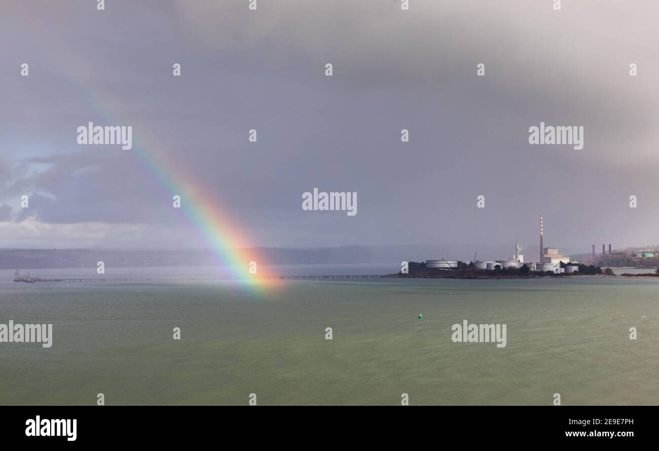 Whitegate, Cork, 04th February, 2021. A rainbow breaks through the clouds close to the storage tanks at the oil refinery in Whitegate, Co. Cork, Ireland. - Credit; David Creedon / Alamy Live News Stock Photo