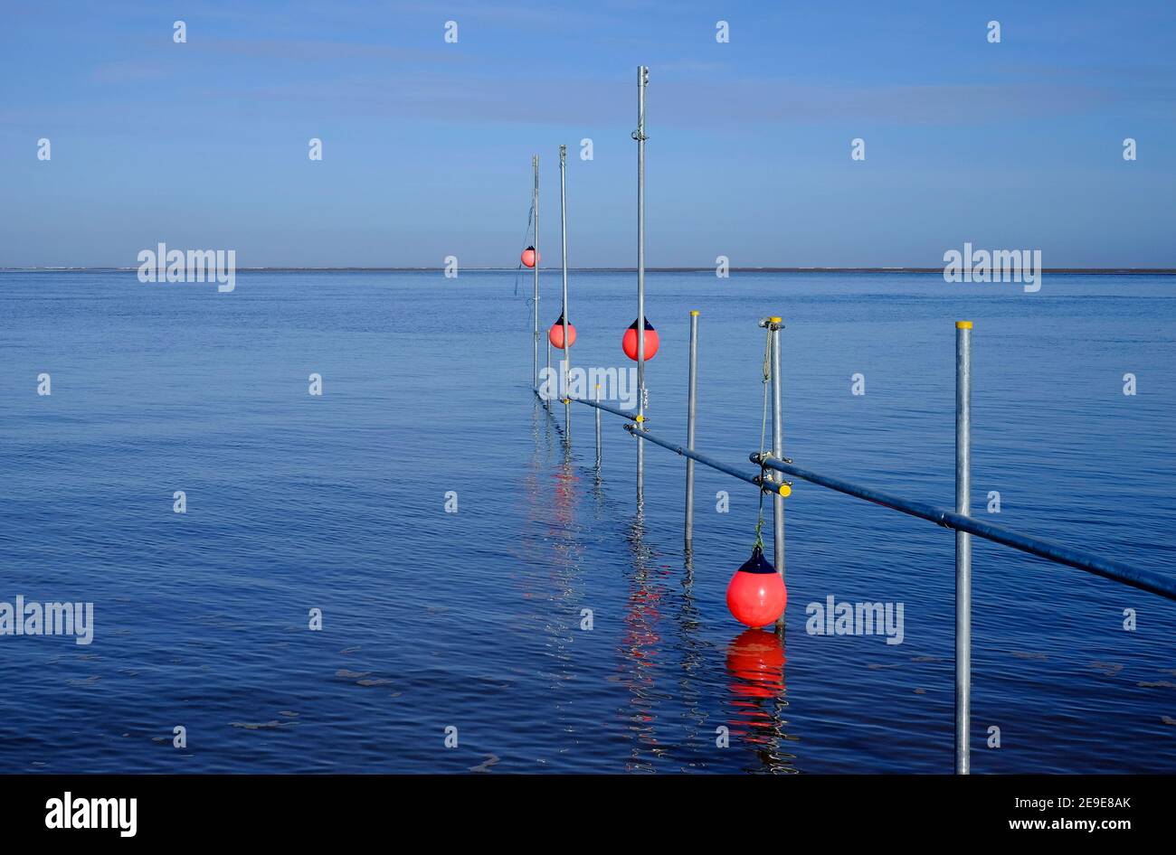 https://c8.alamy.com/comp/2E9E8AK/scaffold-poles-and-red-marker-buoys-in-sea-wells-next-the-sea-north-norfolk-england-2E9E8AK.jpg