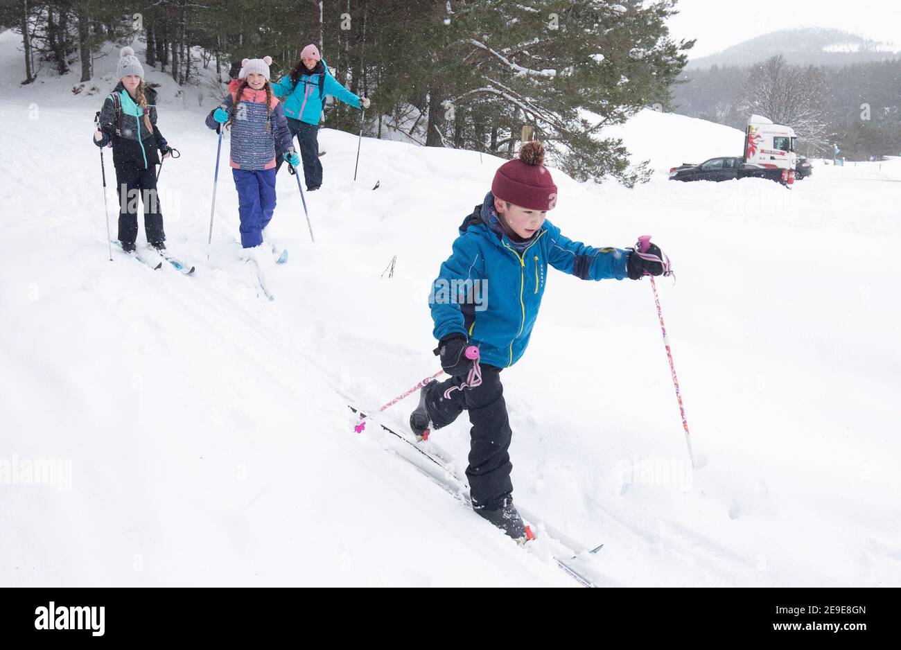 Sarah Caird cross-country skiing, with her children Alex, 11, Lexi, 10 and Coby, six, in the Cairngorm National Park near Aviemore. Picture date: Thursday February 4, 2021. Stock Photo