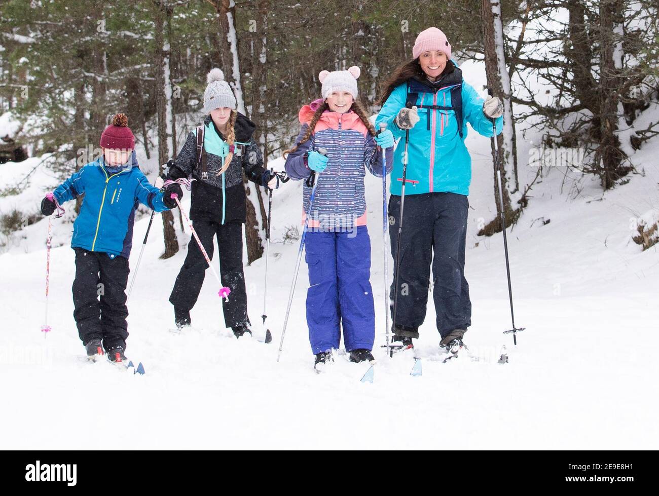 Sarah Caird cross-country skiing, with her children Alex, 11, Lexi, 10 and Coby, six, in the Cairngorm National Park near Aviemore. Picture date: Thursday February 4, 2021. Stock Photo