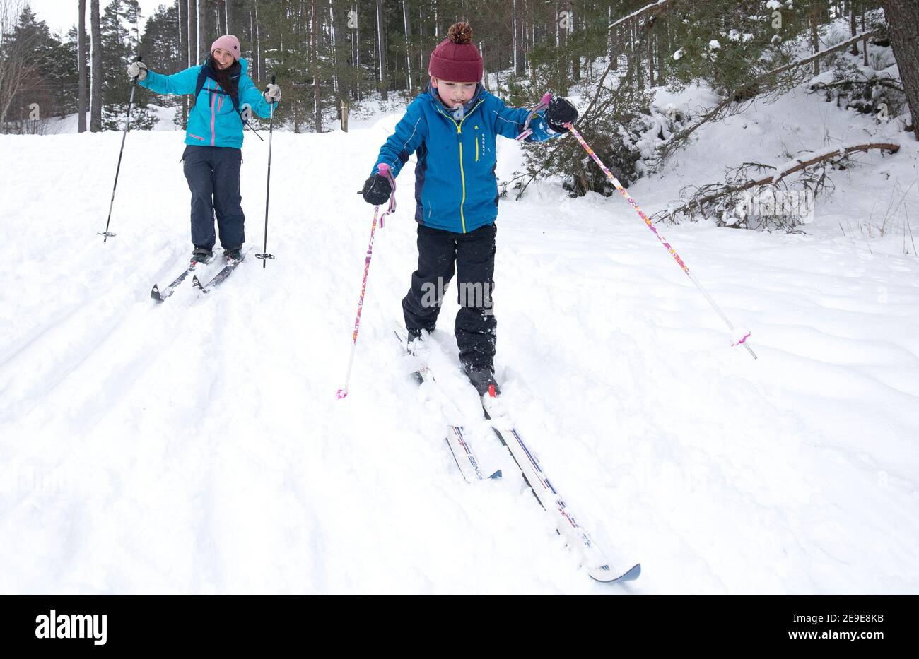 Sarah Caird cross-country skiing, with her son Coby, six, in the Cairngorm National Park near Aviemore. Picture date: Thursday February 4, 2021. Stock Photo