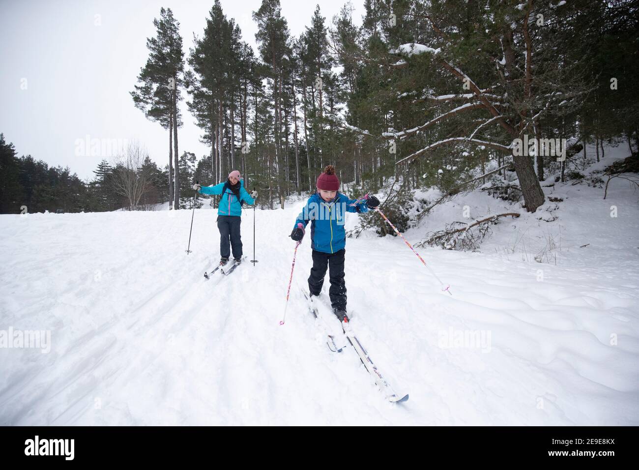 Sarah Caird cross-country skiing, with her son Coby, six, in the Cairngorm National Park near Aviemore. Picture date: Thursday February 4, 2021. Stock Photo