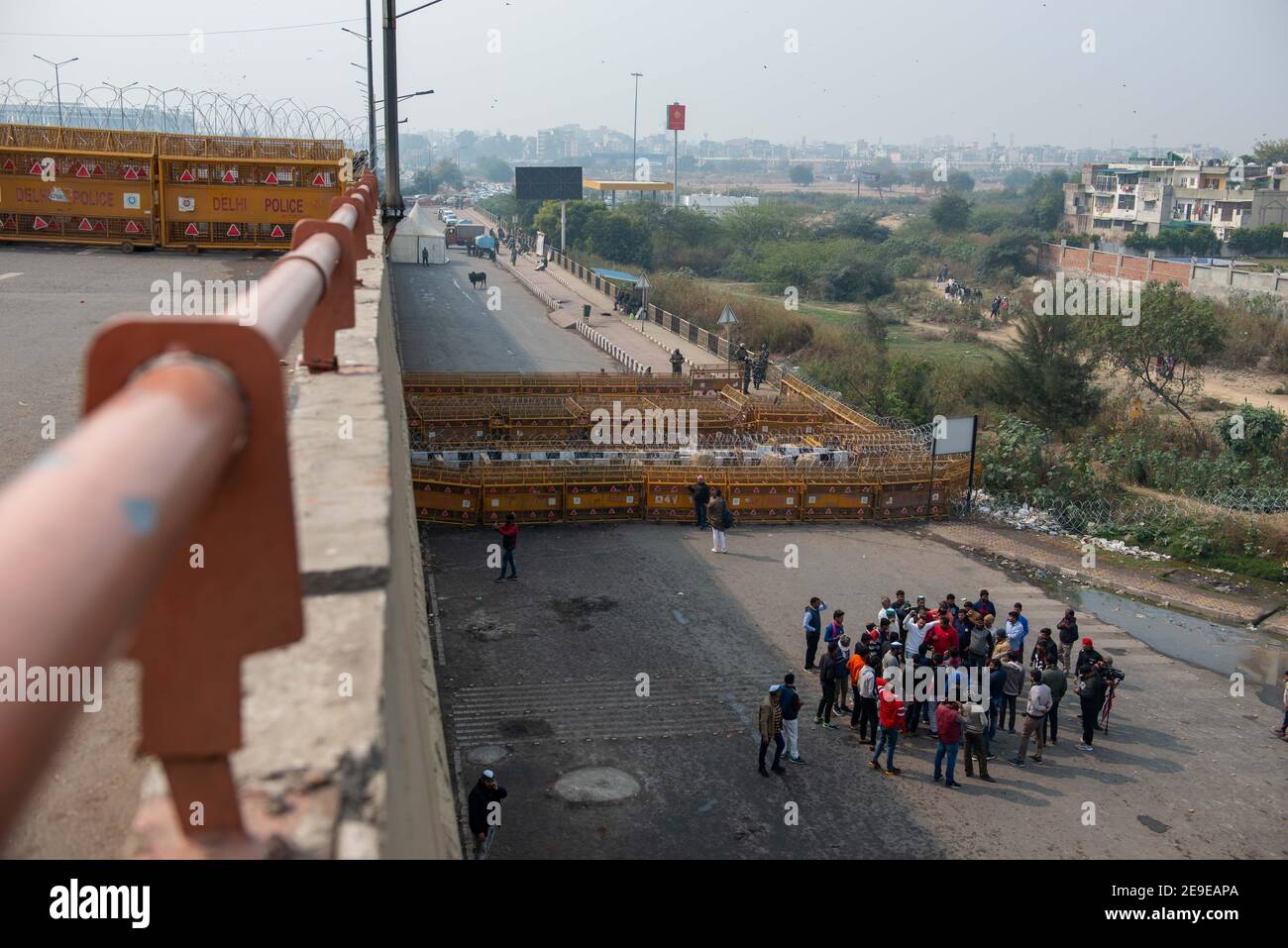 Layers of police barricading and concertina wire laid out at Ghazipur border, during the demonstration.Farmers protests continue for the 70th day as police seal the border with Barbed wire and concrete wall after the Republic day violence. Stock Photo