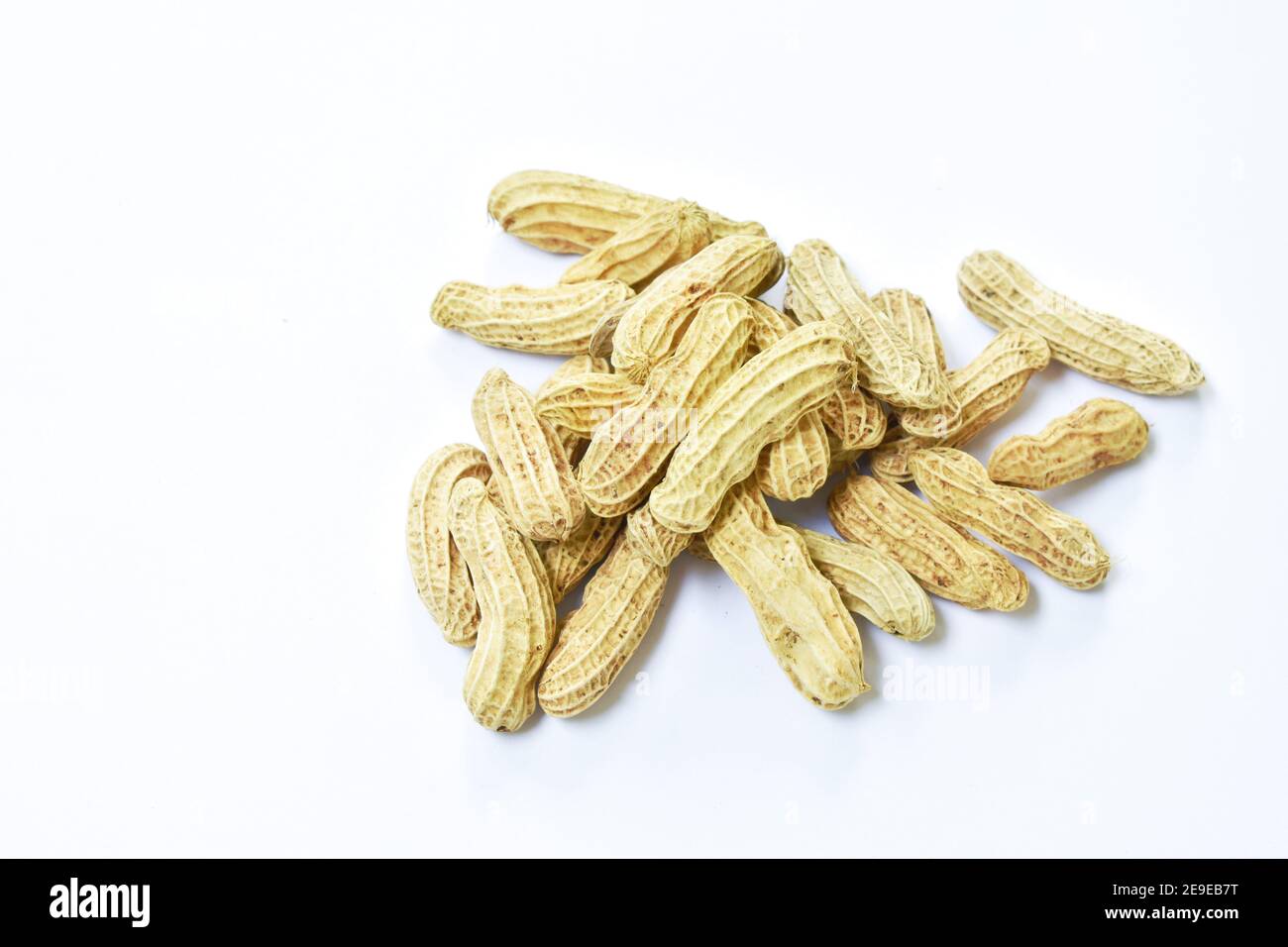boiled peanuts with peel on white background Stock Photo