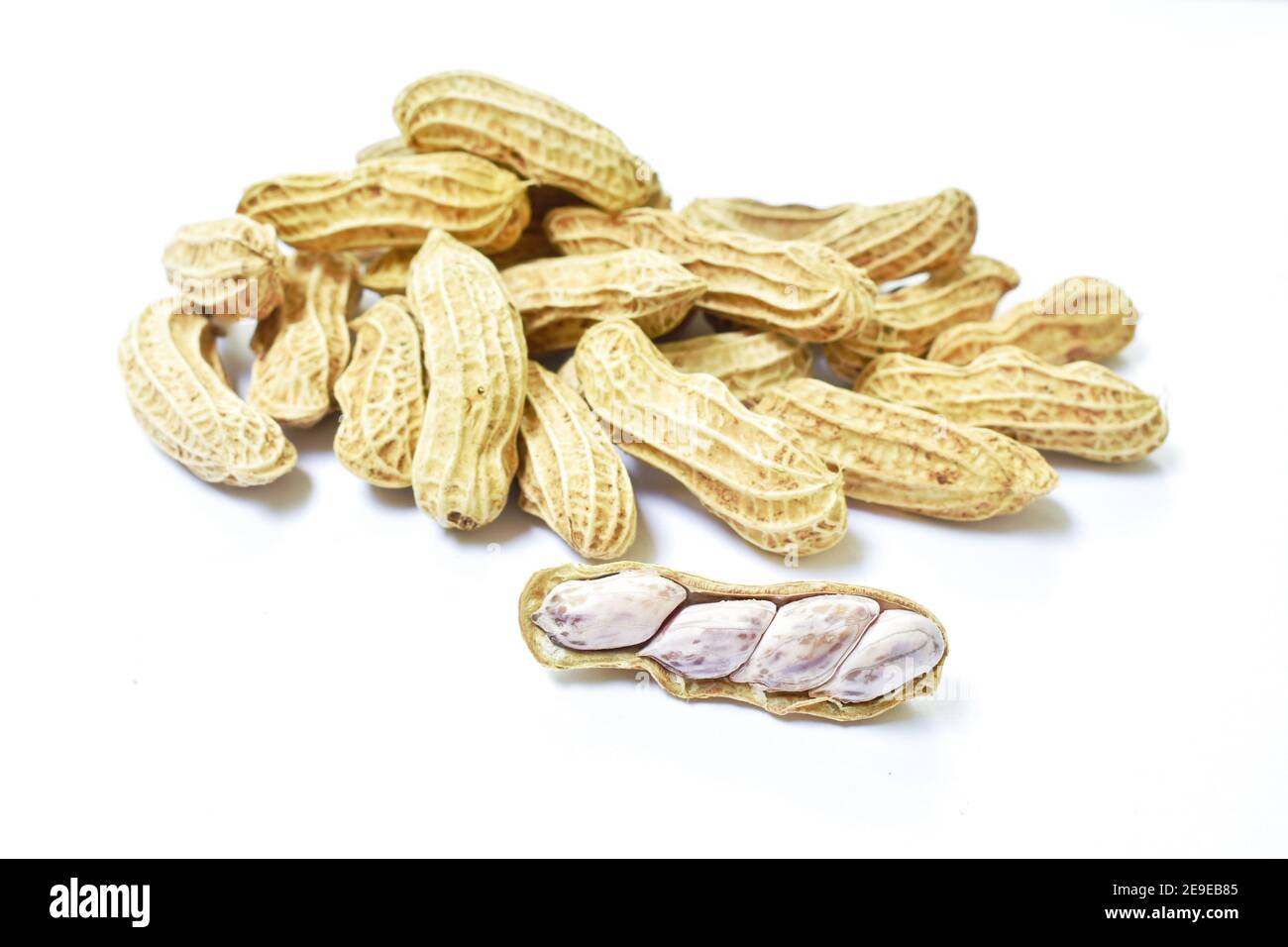 boiled peanuts with peel on white background Stock Photo
