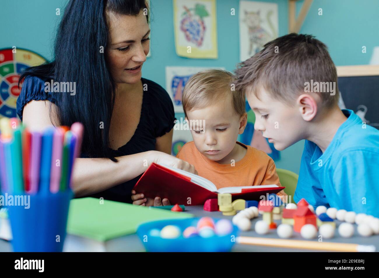 Mother reading a book to her children Stock Photo