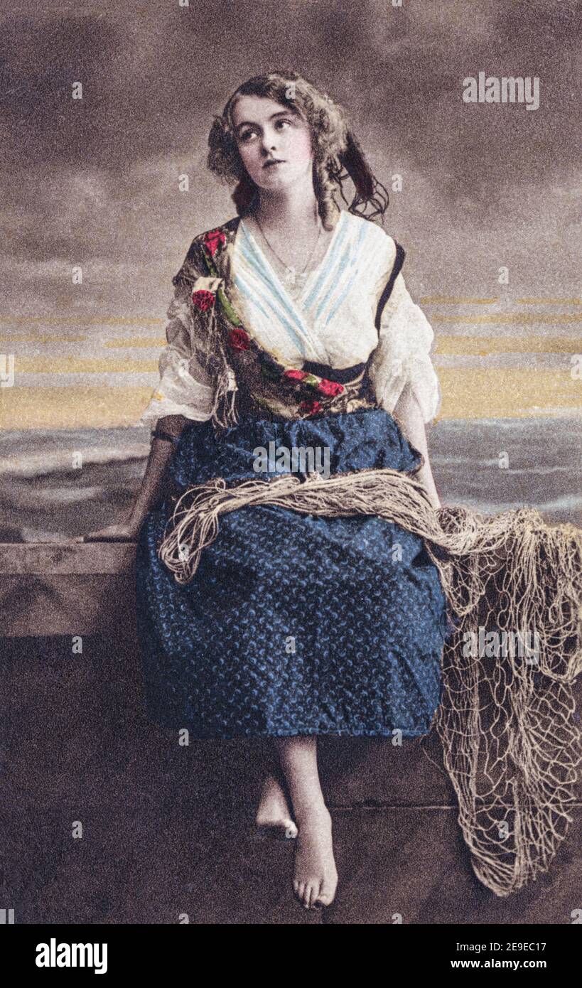 A studio depiction of a fisher girl or fishwife on a coloured real photogravure postcard posted in 1913. Stock Photo