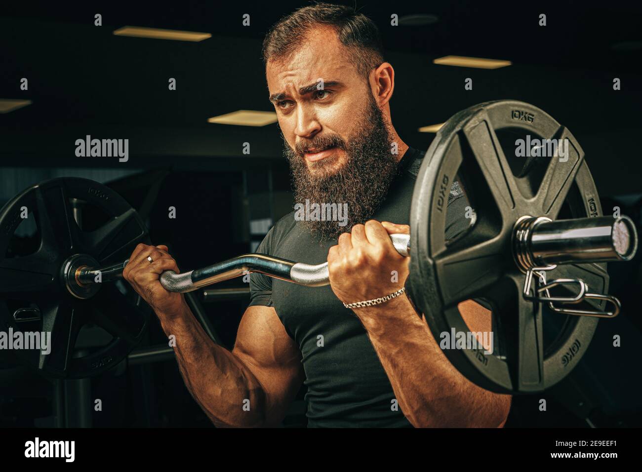 Powerlifter with strong arms lifting barbell in a gym Stock Photo Alamy