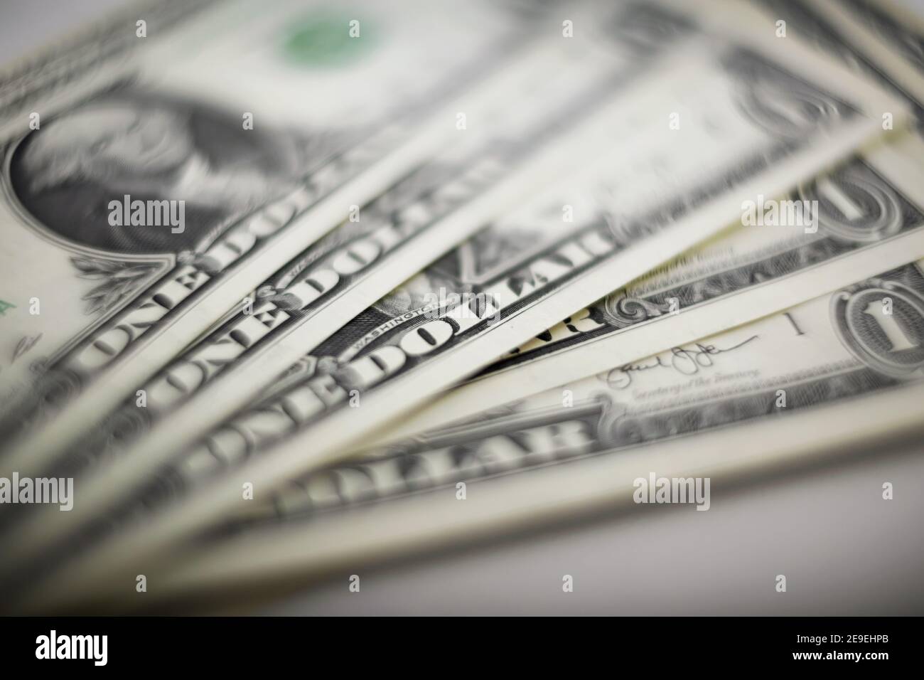 Blurry background with one-dollar bills. A wad of dollars Stock Photo ...