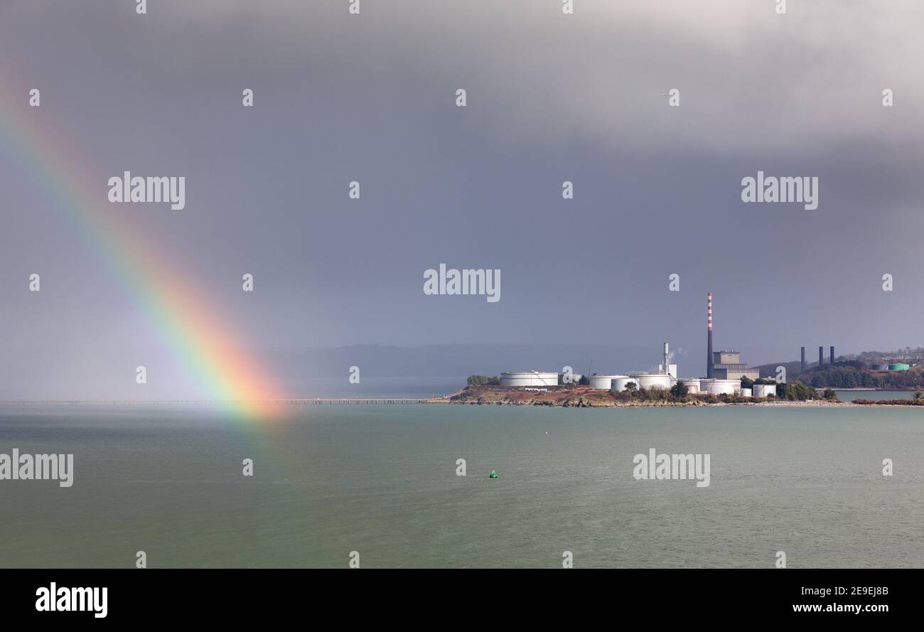 Whitegate, Cork, 04th February, 2021. A rainbow breaks through the clouds close to the storage tanks at the oil refinery in Whitegate, Co. Cork, Ireland. - Credit; David Creedon / Alamy Live News Stock Photo