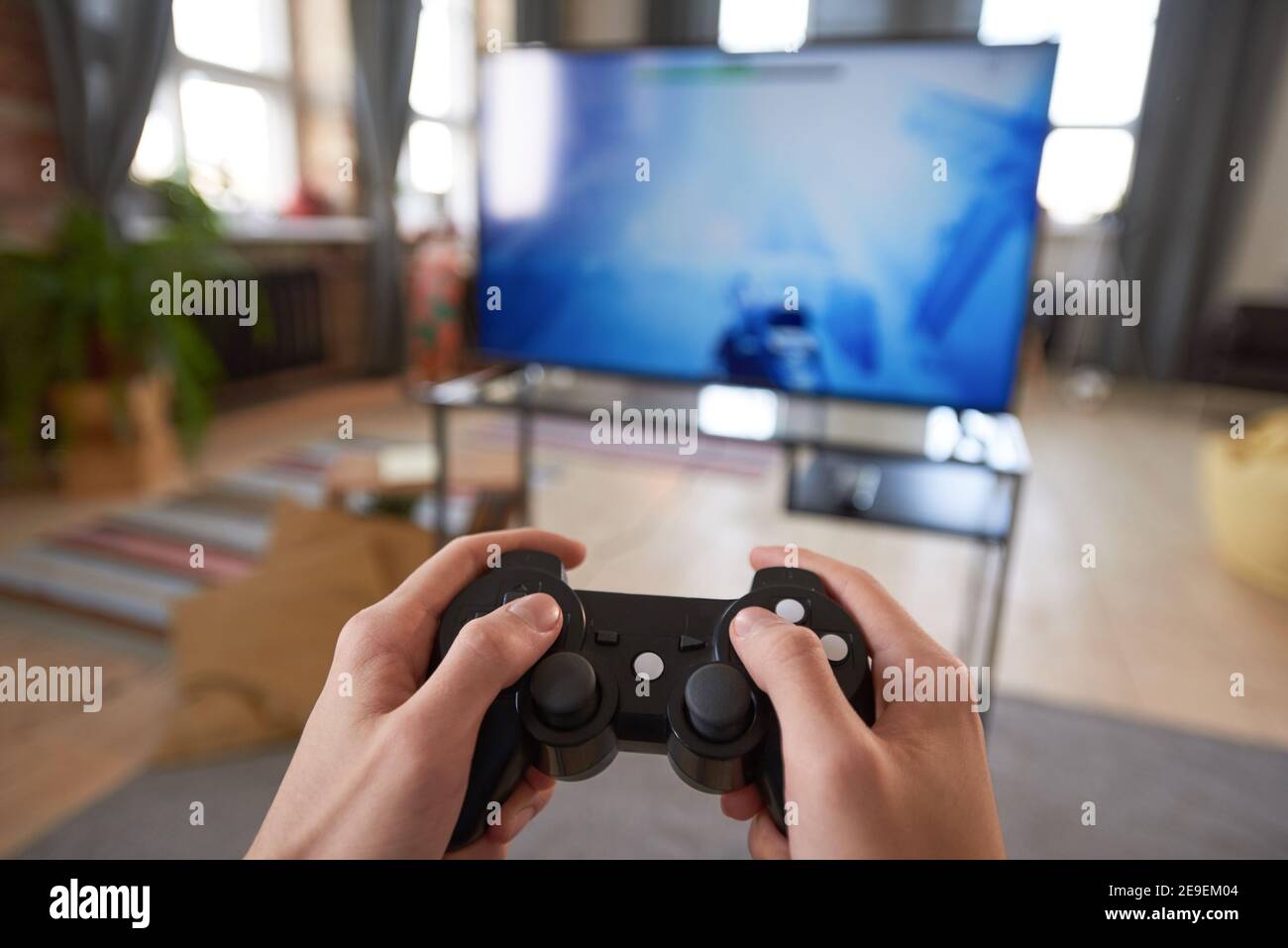 Premium Photo  Close up of gamer holding controller to play video games in  front of computer. player using joystick and playing online games on  monitor, sitting at desk. man gaming with