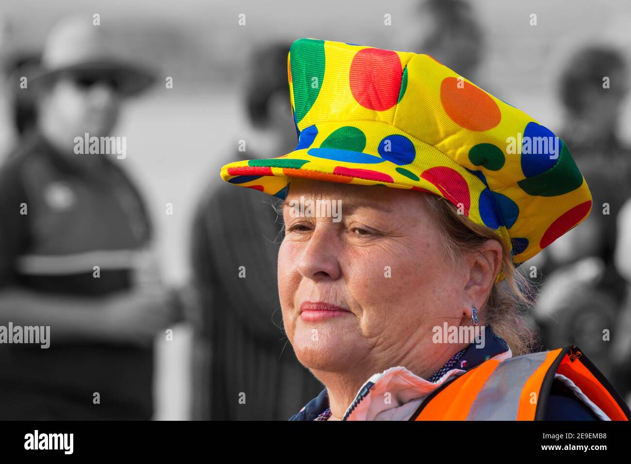 Woman wearing colourful spotty hat cap takes part in Weymouth Carnival at Weymouth, Dorset UK in August Stock Photo