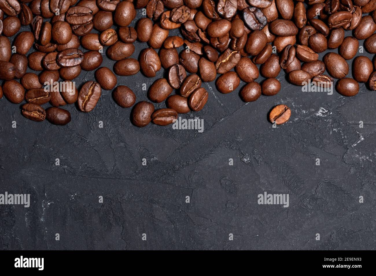 Fresh brown roasted coffee beans on a black table background Stock ...