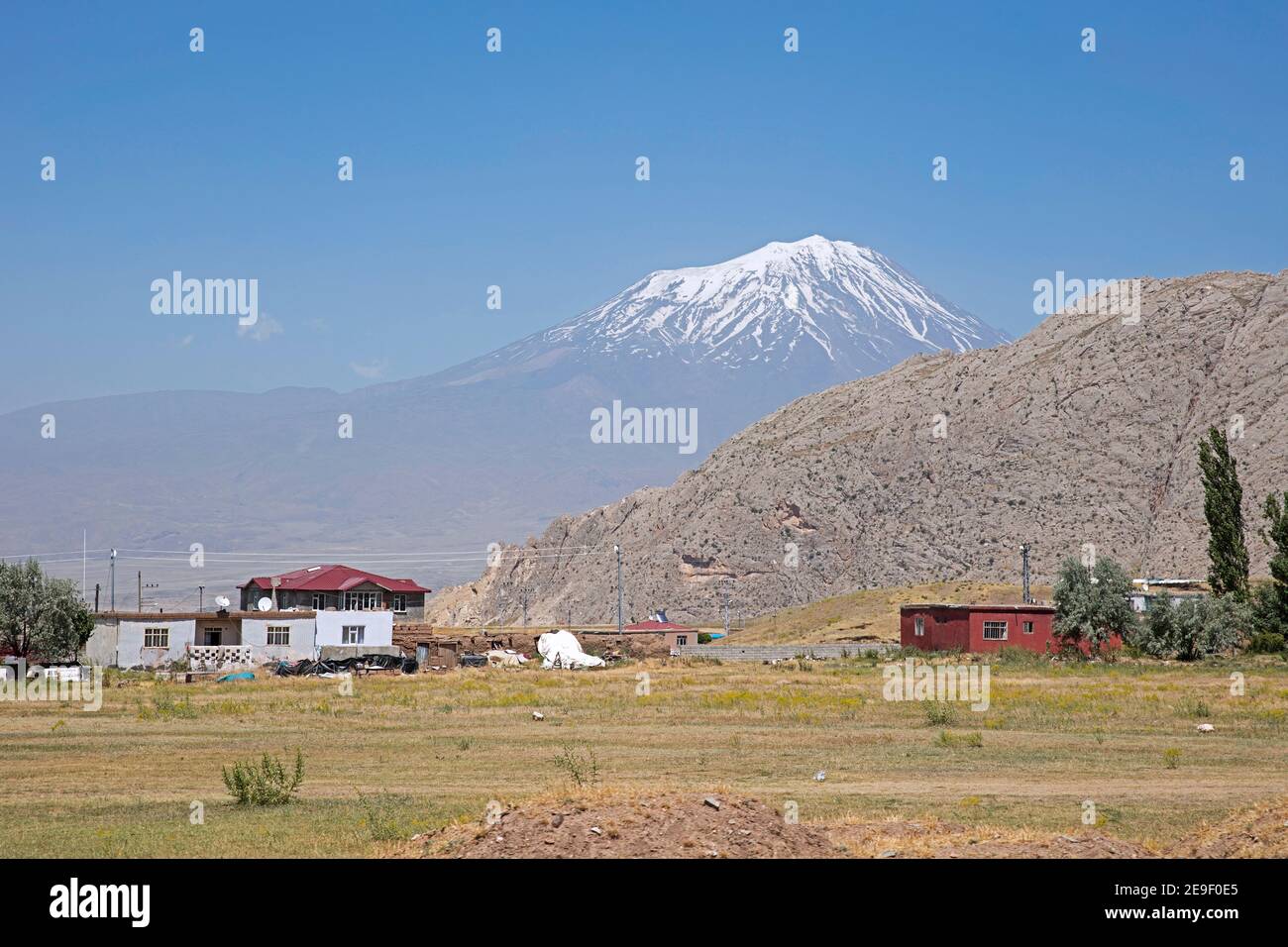 Turkish farm and Mount Ararat / Greater Ararat, snow-capped and dormant  polygenic, compound stratovolcano / volcano in the extreme east of Turkey Stock Photo