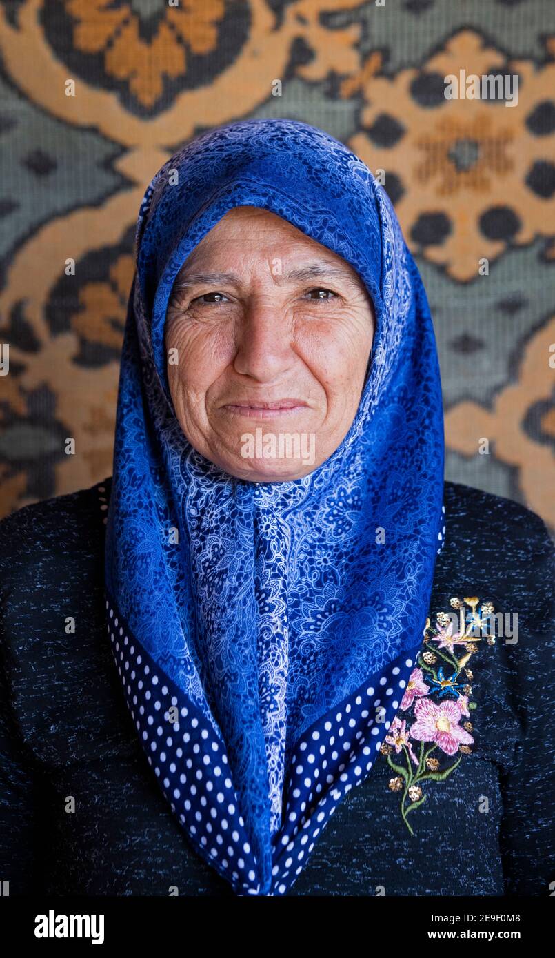 Close-up portrait of Turkish woman wearing blue headscarf / scarf in Cappadocia, Nevşehir Province in Central Anatolia, Turkey Stock Photo