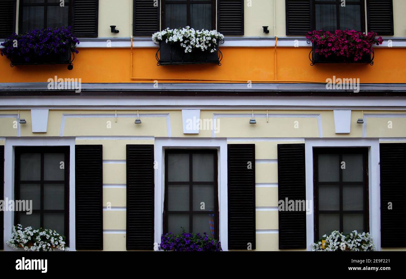 Front Part Of Colored Building House With Shutters Stock Photo