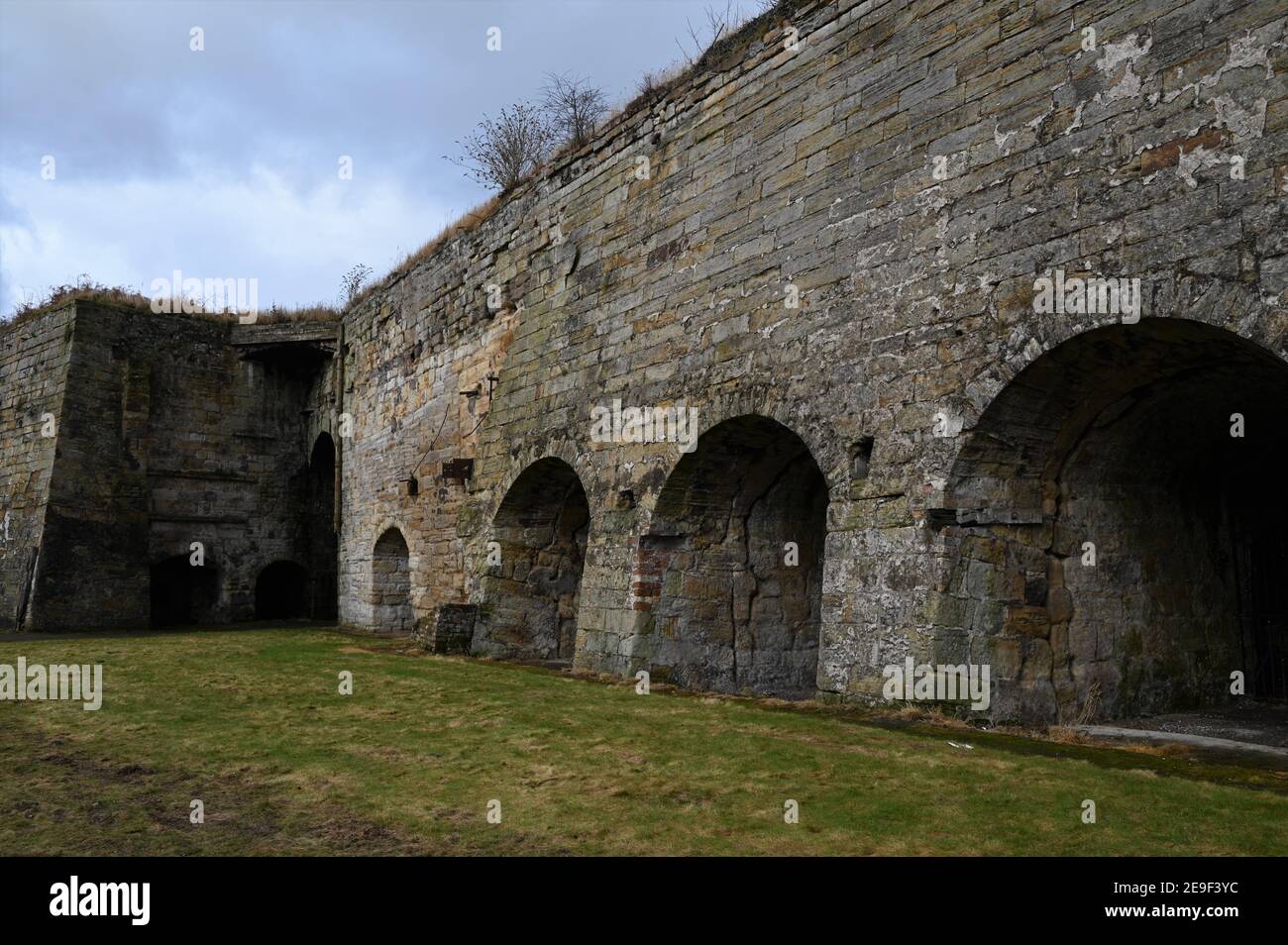 An exterior view of an old stone built lime kiln in the Fife coastal
