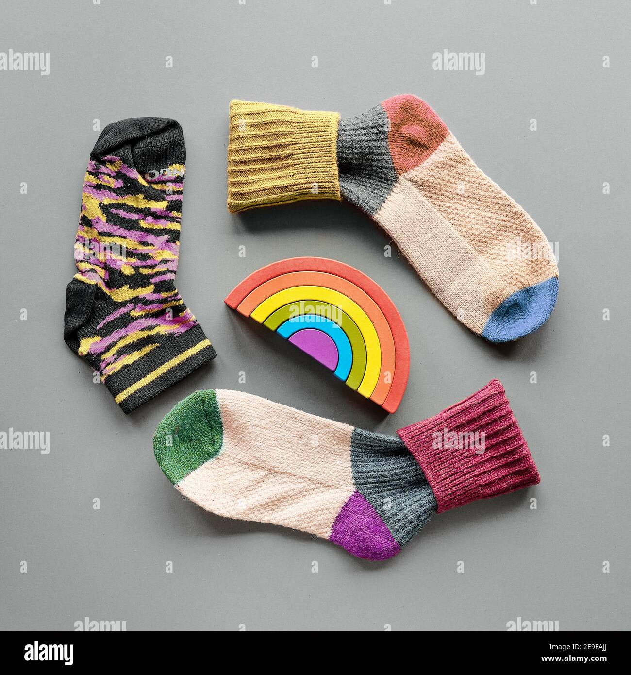 Odd Socks Day. Mismatched socks and rainbow toy. Social initiative