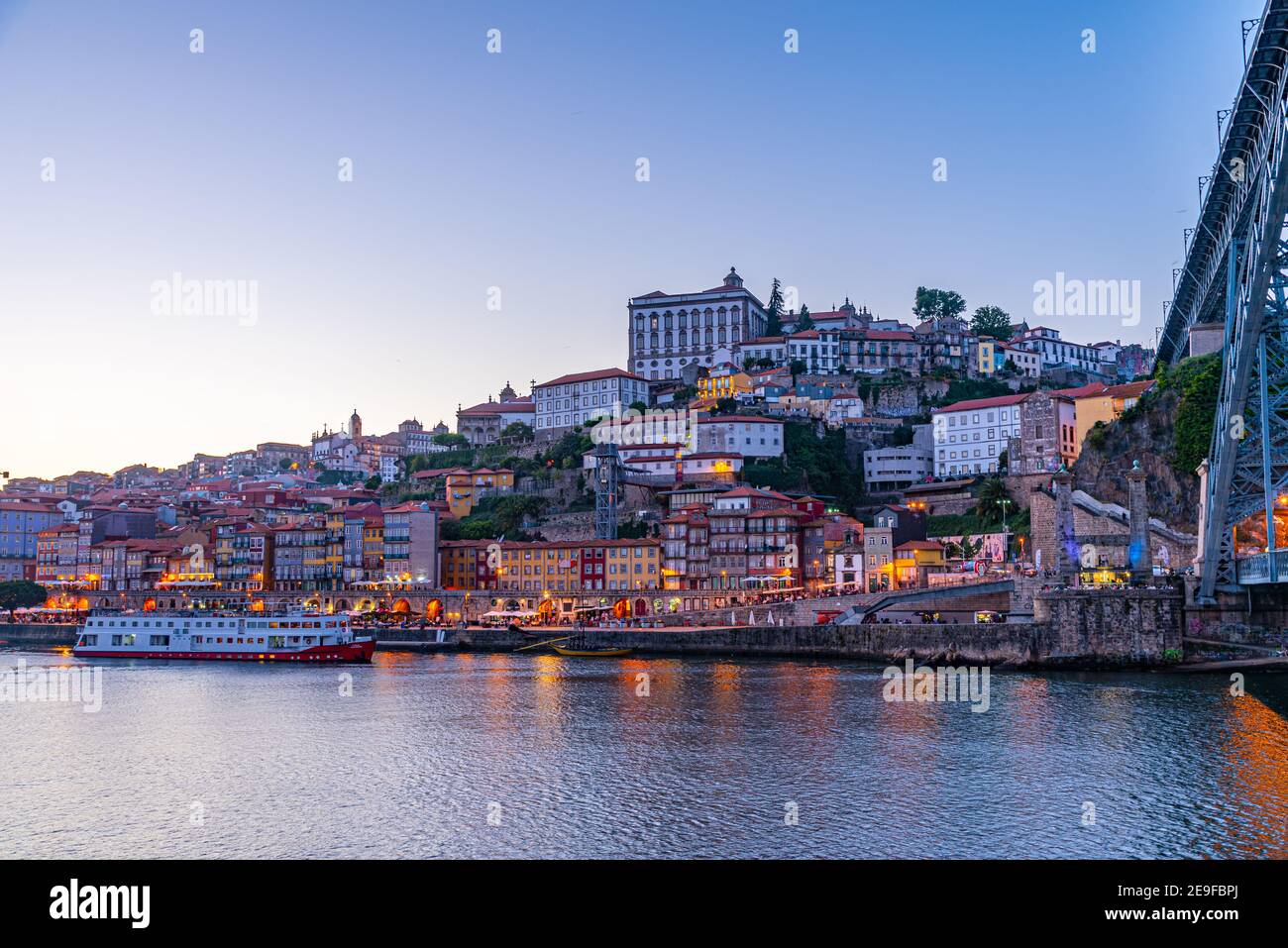 Sunset view of riverside of Douro and episcopal palace in Porto