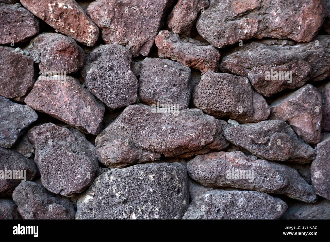 A fence made from volcanic lava rocks in Palm Springs, California. Stock Photo