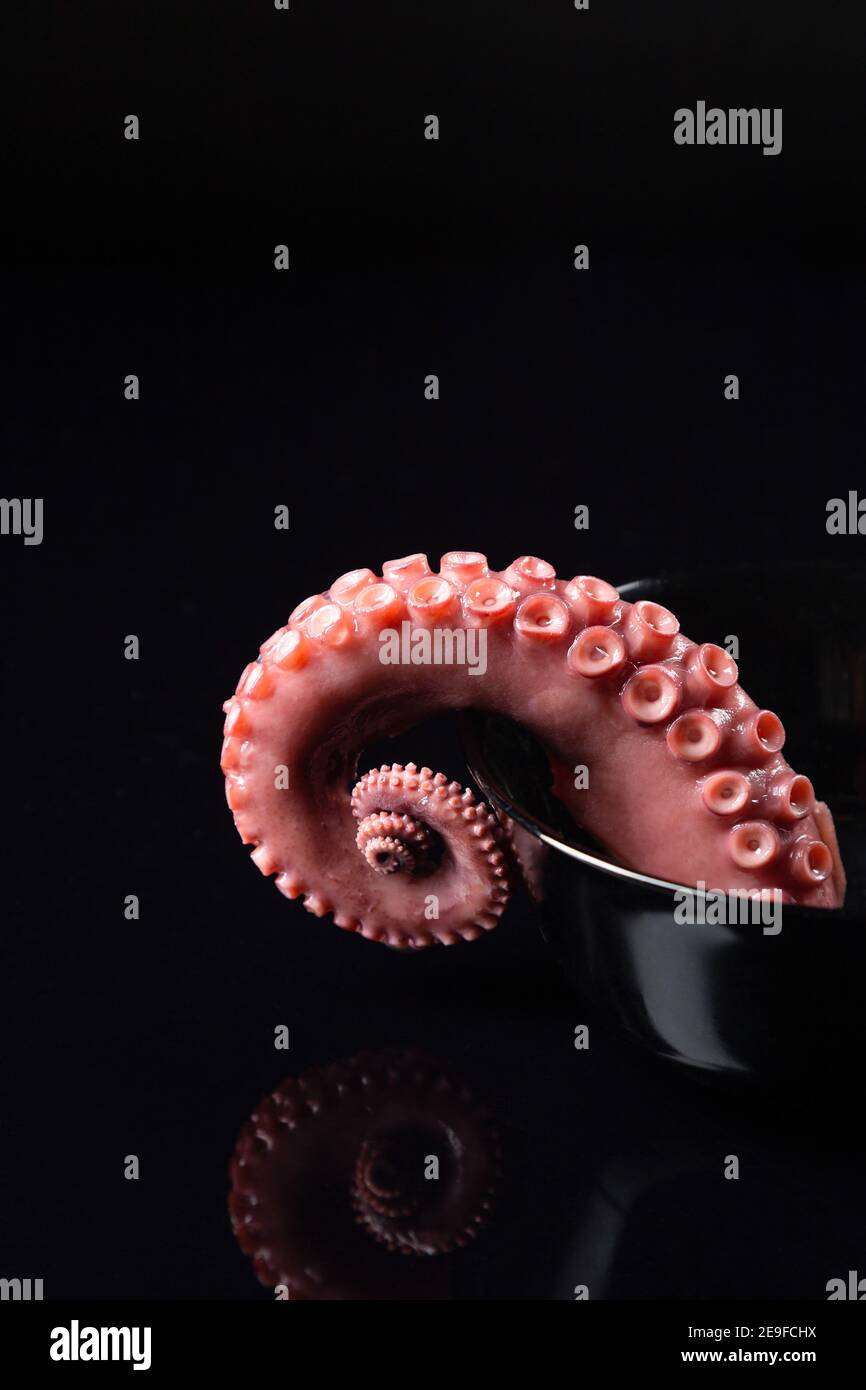 tentacle of stew octopus on dark background Stock Photo - Alamy