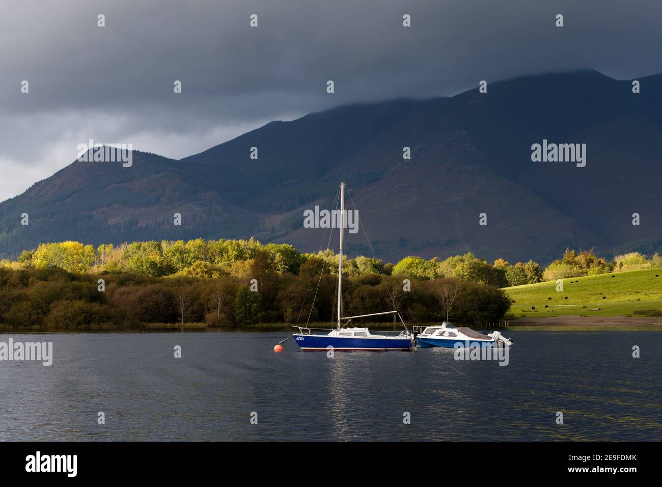 Sail boats on Derwent Water in dramatic lighting Keswick Lake District Cumbria Stock Photo