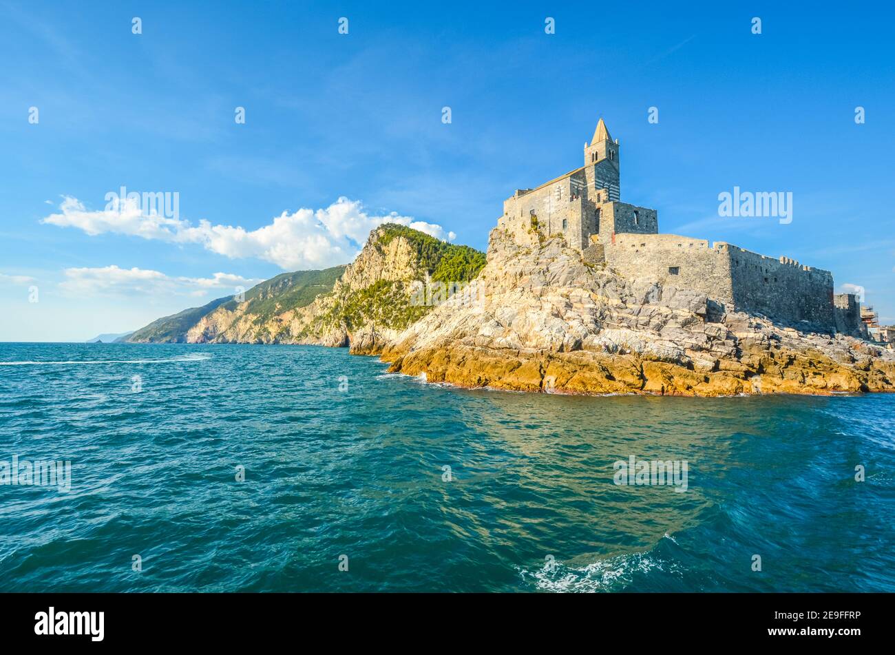 The imposing Church of St. Peter and the Doria Castle on the rocky peninsula at the entrance to Porto Venere Italy on the Ligurian Coast. Stock Photo