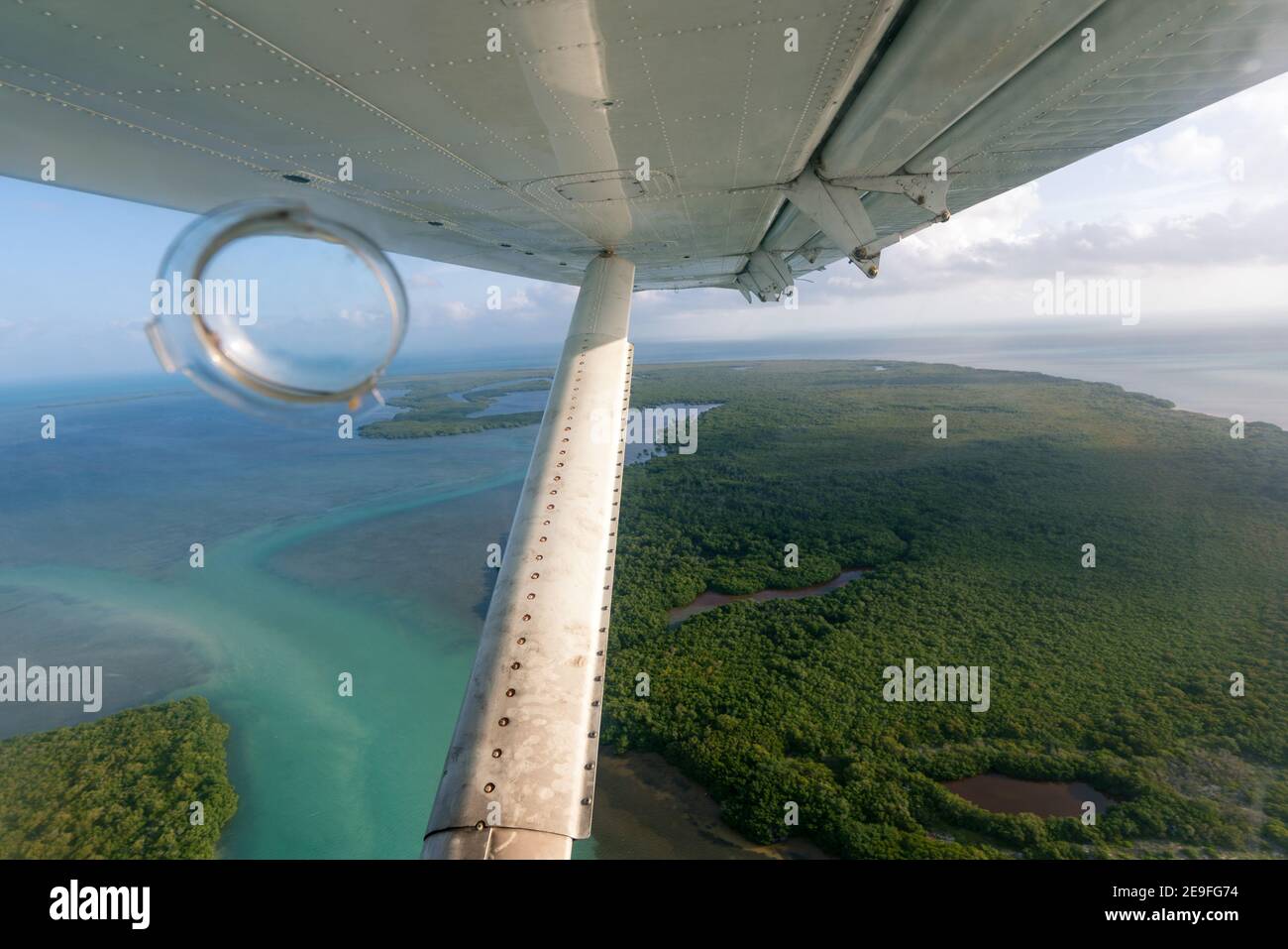 Aerial view from the window of a small hydroplane flying over Key West,Dry Tortugas, Florida. Wing and strut in the view. Stock Photo