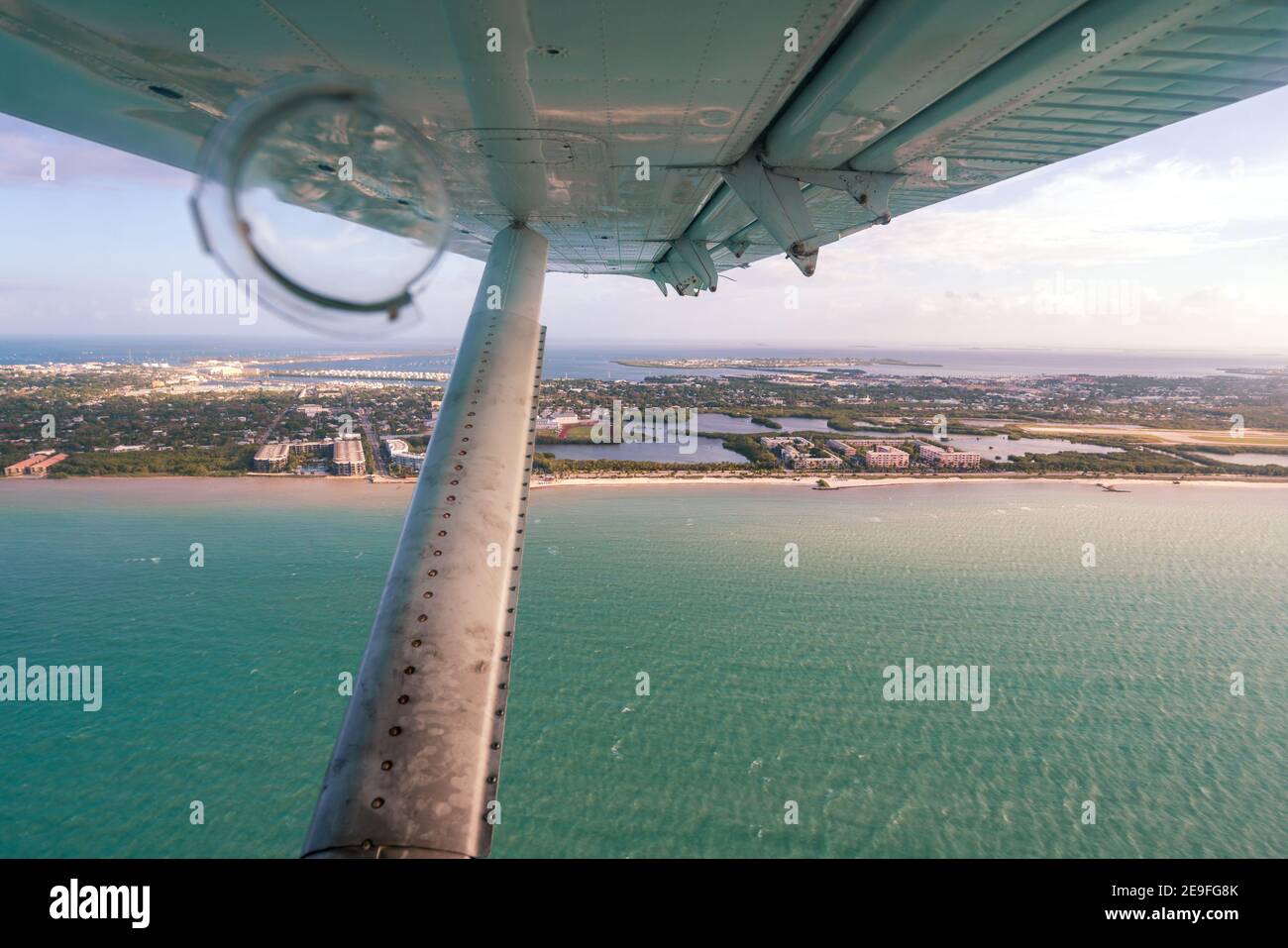 Aerial view from the window of a small hydroplane flying over Key West, Dry Tortugas, Florida. Wing and strut in the view. Stock Photo