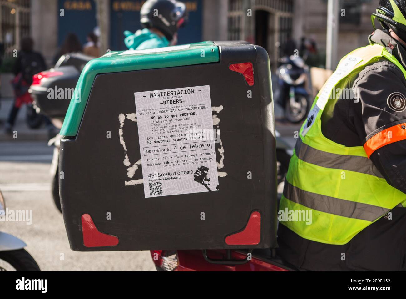 Delivery man is seen with a sign on his bag during the  demonstration.Hundreds of delivery people from different home delivery  platforms such as Deliveroo, Uber Eats, Glovo, Stuart and also from Amazon