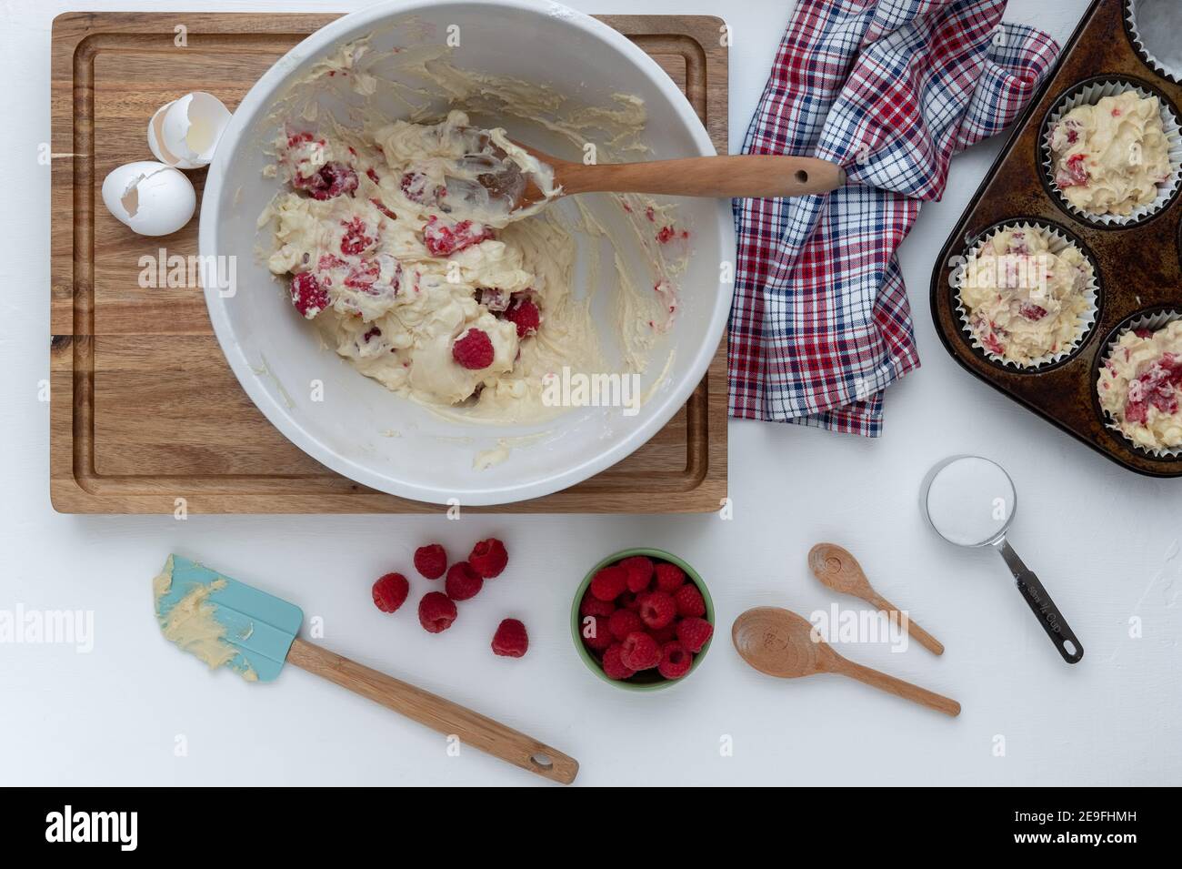 Making raspberry muffins in the kitchen Stock Photo