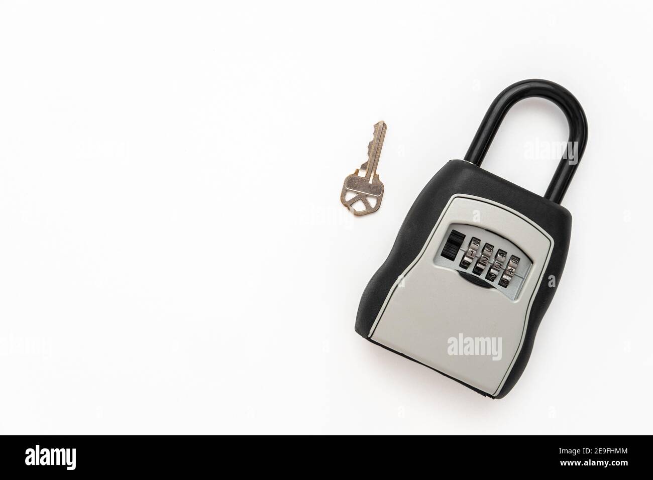 Real Estate Lock Box with a key with copy space Stock Photo