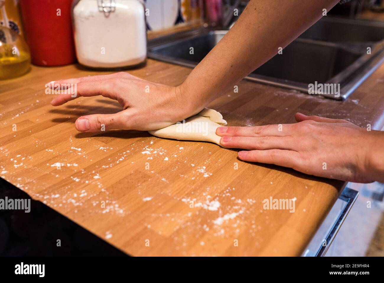 Hands kneading dough on board sprinkled with flour Stock Photo Alamy