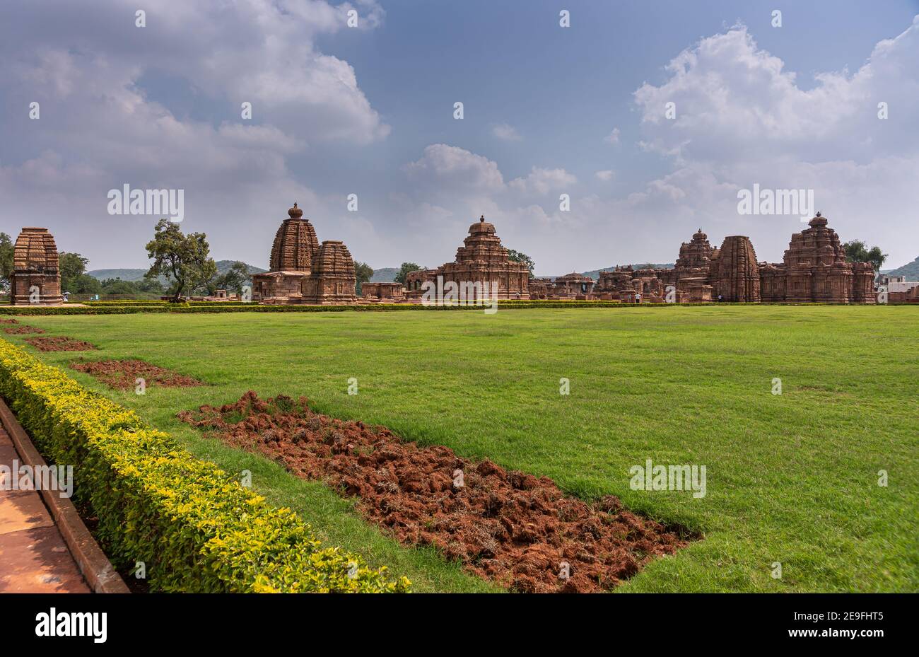 Bagalakote, Karnataka, India - November 7, 2013: Pattadakal temple complex. Wide landscape view on conglomerate of brown buildings under blue cloudsca Stock Photo
