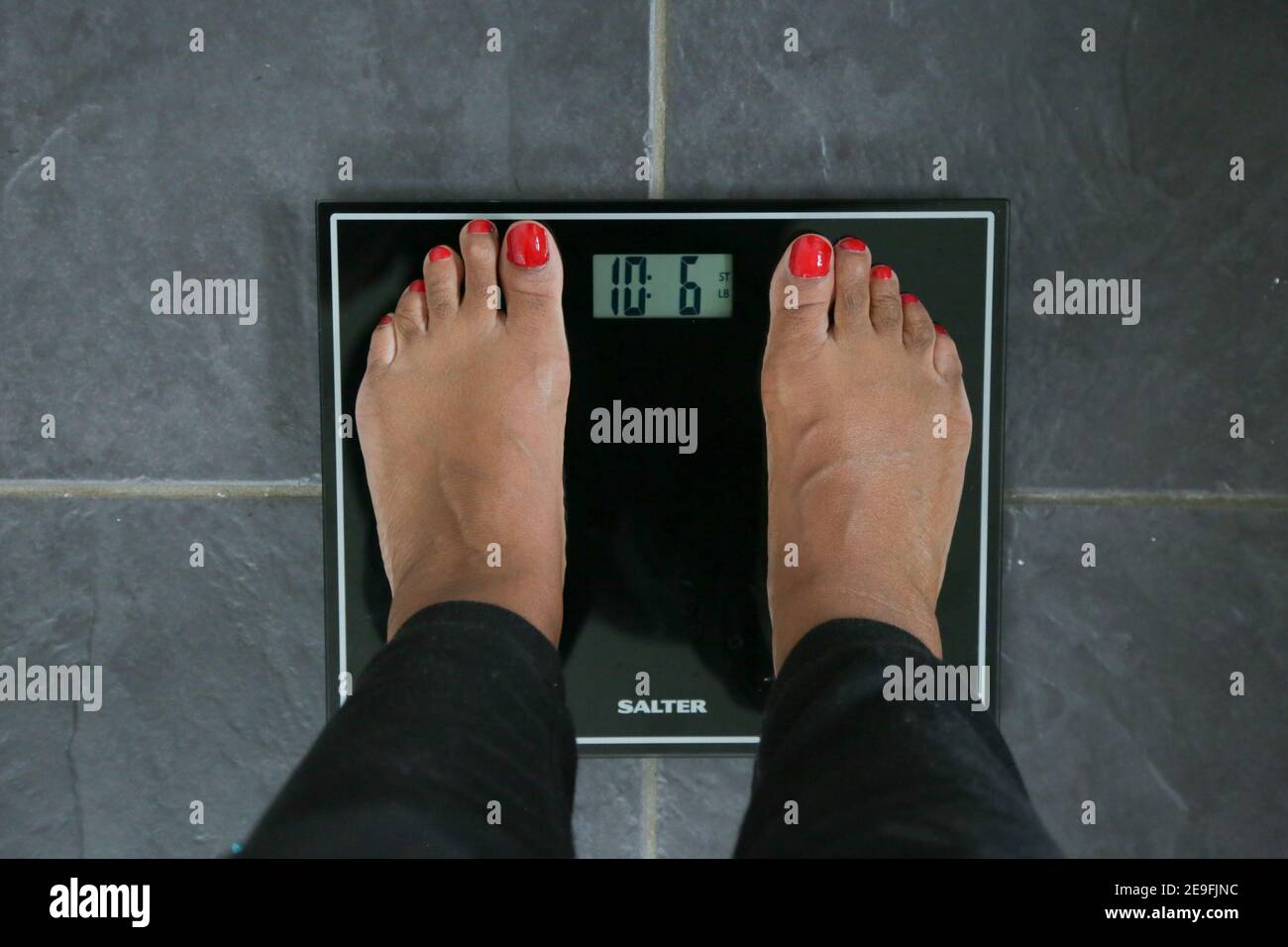Gaining weight during lockdown, black female feet Stock Photo Alamy