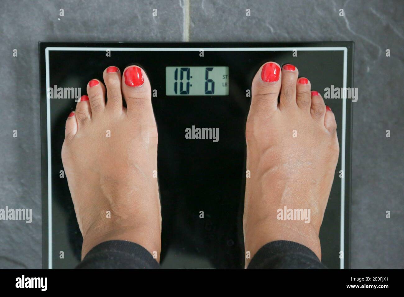 Gaining weight during lockdown, black female feet Stock Photo Alamy